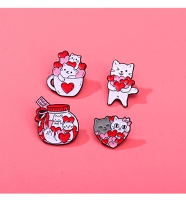 Detailed view of four cartoon cat enamel pins in pink, white and red styles
