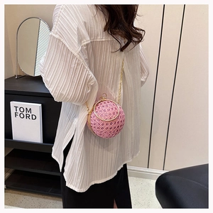 Detail of pink rhinestone round evening bag with gold ring handle and chain strap