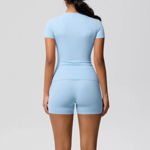 Rear view of light blue fitness set featuring breathable short sleeve top and yoga shorts