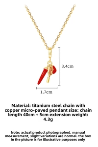 Detail of titanium steel gold necklace with red heart, chili and racket charms
