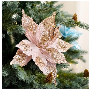 Close-up of pale pink velvet poinsettia with champagne gold glitter on Christmas tree