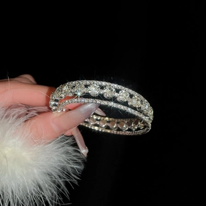 Macro detail of silver multi-layer floral bracelet featuring triple-row crystal stones