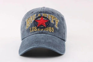 Detail of washed grey-blue baseball cap with red star and Hilarity embroidery texture