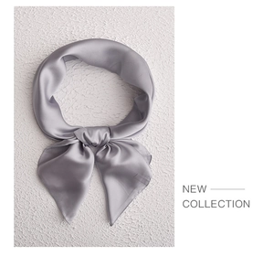Close-up of a knotted grey satin silk scarf showing its smooth and glossy texture