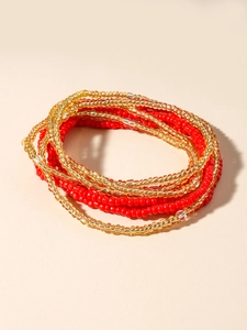 Close-up of bohemian layered red and gold glass seed beads hand-woven waist chain
