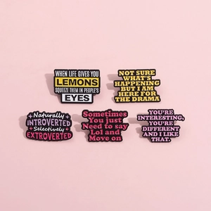 Five-piece set of colorful enamel pins with humorous slogans on a pink background