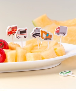 Detailed close-up of cartoon construction and emergency vehicle food picks for kids