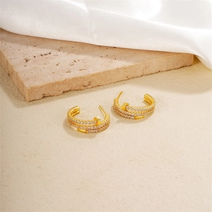 Gold-plated C-shaped nail earrings featuring triple rows of micro-pave cubic zirconia