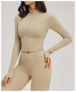 Detail of slim fit yoga jacket thumbhole cuffs and pockets on high waist leggings