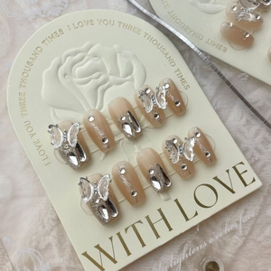 Handmade butterfly press-on nails set in nude gradient with silver glitter and rhinestones