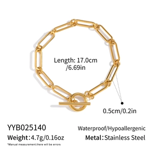 Detail showing gold paperclip chain bracelet with OT toggle clasp and product dimensions