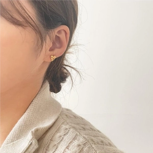 Elegant gold heart stud earrings shown on model for daily style and accessory reference