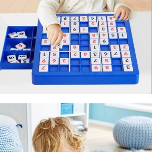 Child placing number blocks on a blue Sudoku game board for logical thinking skills