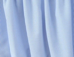Close-up of blue and white striped fabric texture showing fine vertical seersucker weave