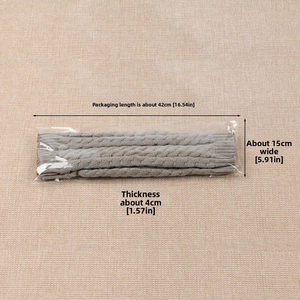 Detail showing the gray cable knit leg warmer packaged with dimensions 42cm x 15cm x 4cm