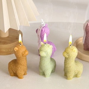 Colorful alpaca shaped scented candles with realistic curly fur texture and warm lighting