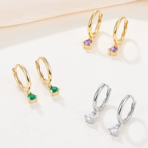 Three pairs of elegant 925 silver hoop earrings set with zircon stones in gold and silver