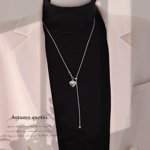 Silver heart pendant Y-necklace with adjustable snake chain on a chic winter outfit