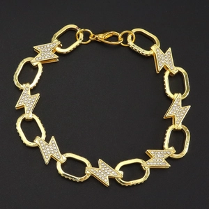 Close-up of gold chain link necklace featuring a sparkling rhinestone lightning bolt charm
