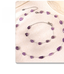 Macro shot of bohemian purple natural stone necklace and bracelet with silver finish