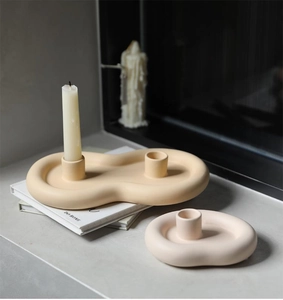 Close-up of cloud-shaped ceramic candle holder with organic lines and matte finish