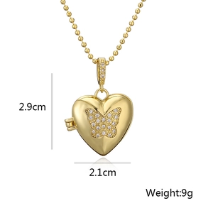 Close-up of gold heart locket pendant with crystal butterfly and size measurements