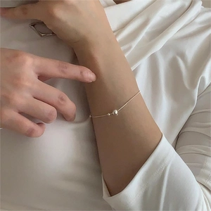 Close-up of a minimalist S925 sterling silver bead snake chain bracelet on a woman wrist