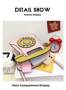 Detail view of pink vintage telephone bag interior showing main compartment and storage