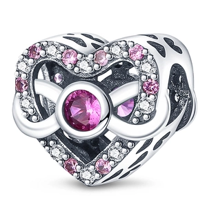 Macro detail of silver hollow heart bead with pink gems and infinity symbol design