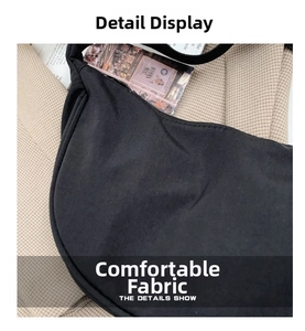 Close-up of durable black nylon fabric texture and stitching on the crossbody dumpling bag