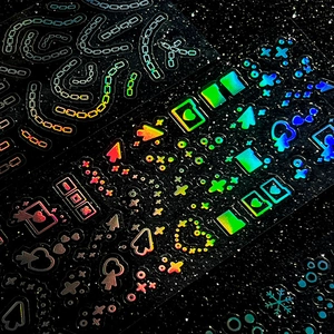 Holographic Y2K laser stickers featuring pixel art icons and rainbow reflective finish