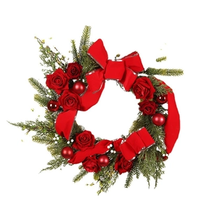 Christmas wreath with red roses, large velvet bow, pine needles and shiny ornaments