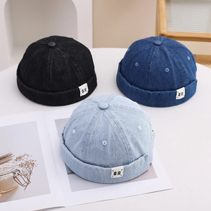 Detailed view of three cotton denim docker hats in black, dark blue, and light blue colors