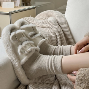 Cozy beige plush double-strap slippers with matching socks in a warm home setting