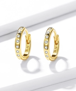 Macro shot of gold-plated S925 sterling silver hoop earrings with white zircon accents