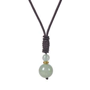 Detail of green tiger eye stones on hand-woven necklace cord with golden metal spacer
