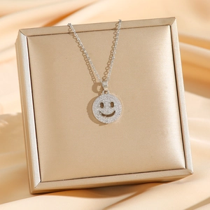 Sparkling silver smiley face pendant necklace with cubic zirconia on a luxury jewelry box