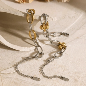 Two-piece mixed metal chain necklace with gold and silver ball bar pendants on ceramic