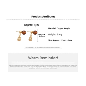 Detailed view of gourd drop earrings with amber bead, sizing and material specs