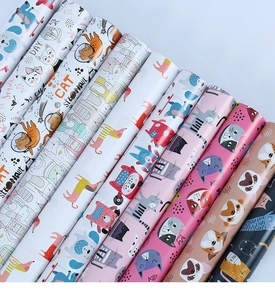 Detailed close-up of colorful cat themed gift wrapping paper with various cartoon patterns