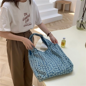 Detail showing spacious light blue floral lace tote bag with 3D texture and soft canvas handles