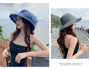 Detail of blue and grey wide brim sun hats with organza flower and mesh decorations