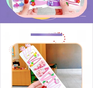 Detail of pink cartoon hair clips with rabbit, flower and bow designs for girls