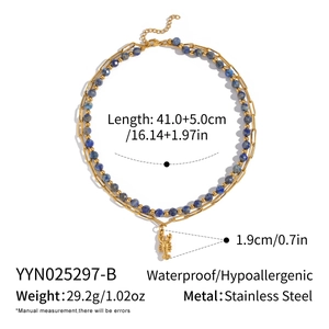Detail view of double-layered stainless steel necklace with blue beads and lobster pendant