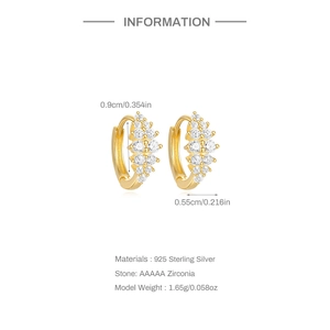 Macro view of gold S925 sterling silver huggie hoops with AAAAA zirconia details