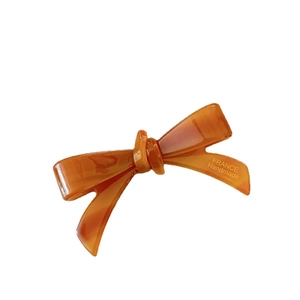 Amber acetate bow hair clip with France Handmade engraving on professional white background