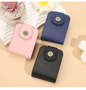 Detailed view of mini makeup pouches with sunflower clasps in pink, navy and black