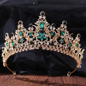 Detailed close-up of emerald and black gemstones set in a golden bridal crown
