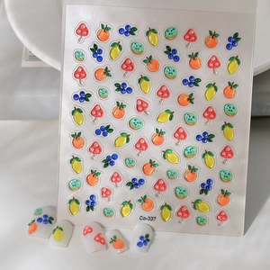 Detail showing 5D embossed fruit and mushroom nail stickers with 3D relief texture