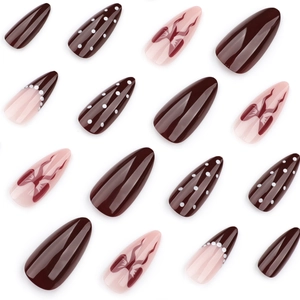 Short almond press-on nails in burgundy and pink with pearls and bow designs